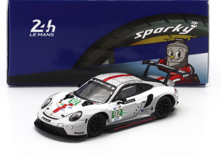 White Porsche 911 RSR model car with number 92 racing decals in front of Sparky 24h Le Mans tire box, available on Vroomi