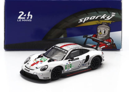White Porsche 911 RSR model car with number 92 racing decals in front of Sparky 24h Le Mans tire box, available on Vroomi