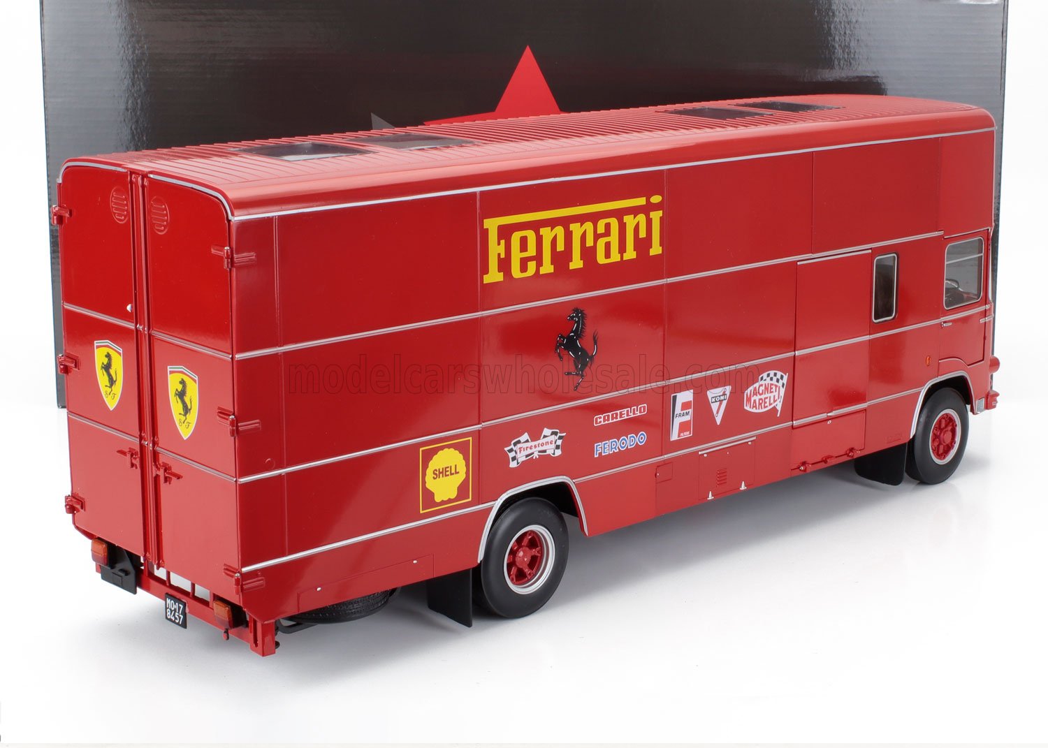 Red Ferrari racing team transporter truck model with sponsor logos, now accessible via Vroomi