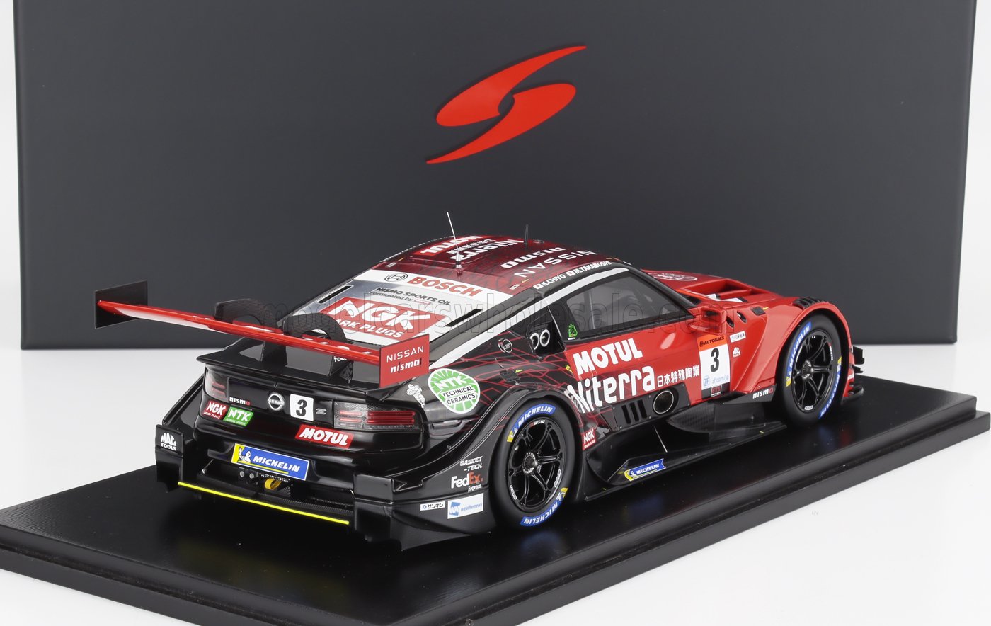 Red and black Nissan Nismo GT race car model with sponsor decals on display, offered on Vroomi