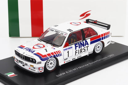 Modèle réduit de voiture de course BMW E30 M3 Monza 1992 blanche avec livrée FINA FIRST motor oil, présenté sur un socle, désormais disponible sur Vroomi.