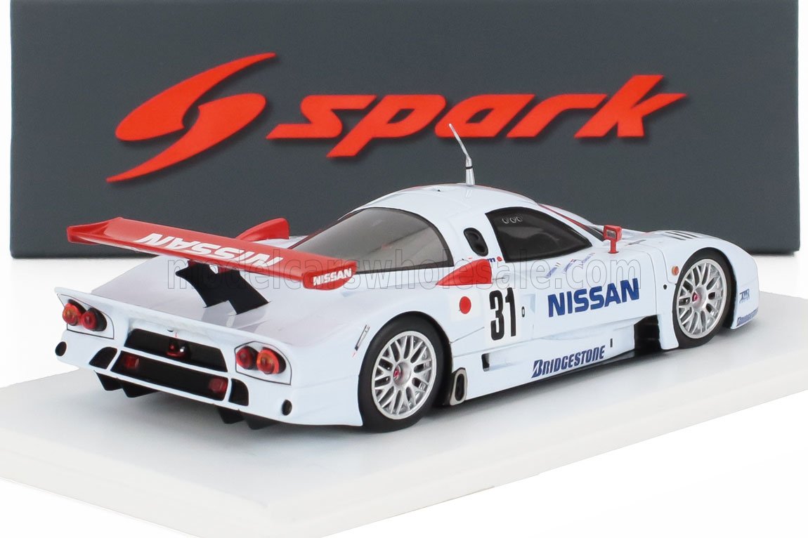 White Nissan race car model with red spoiler, number 31, Bridgestone tires, shown with Spark brand backdrop, available on Vroomi