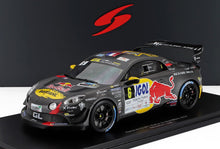 Black Alpine A110 GT rally car with Red Bull and IGOL logos, displayed on a platform, offered via Vroomi