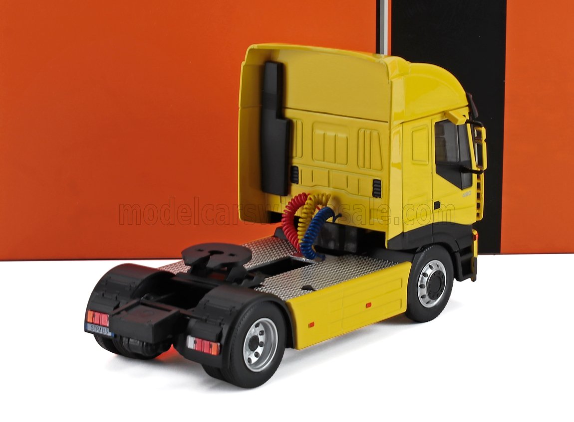 Yellow semi truck tractor model with black and silver details on white and orange background, available on Vroomi