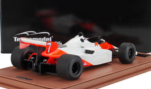 White and red vintage Formula 1 race car model on display with black background, available on Vroomi