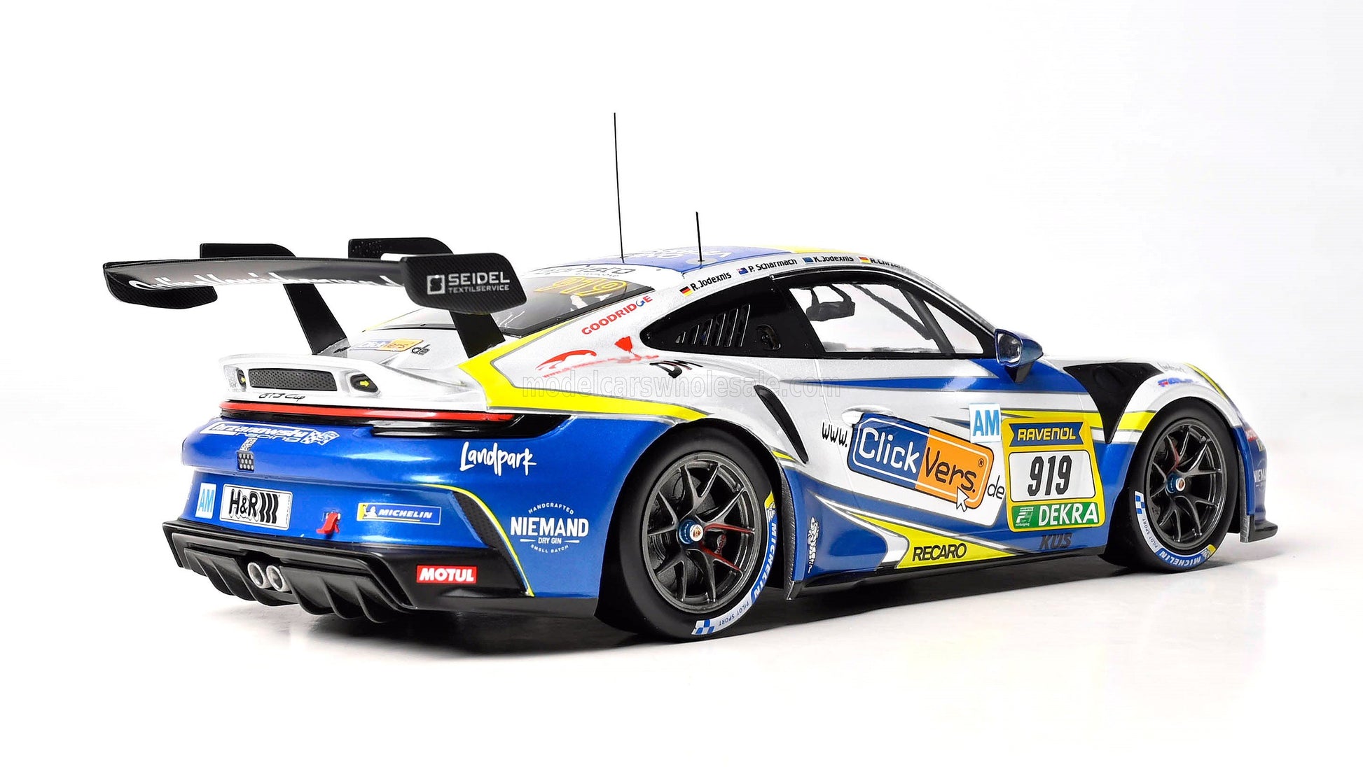 Blue and white Porsche 911 GT3 Cup race car with sponsor decals, rear wing, and Michelin tires, available on Vroomi