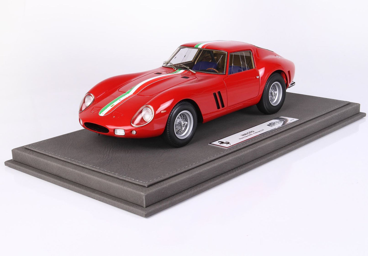 Red Ferrari 250 GTO model car with Italian stripe on display stand, offered on Vroomi