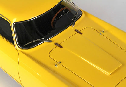 Gros plan sur le capot et le pare-brise jaunes d'une voiture vintage avec un volant marron, disponible via Vroomi.