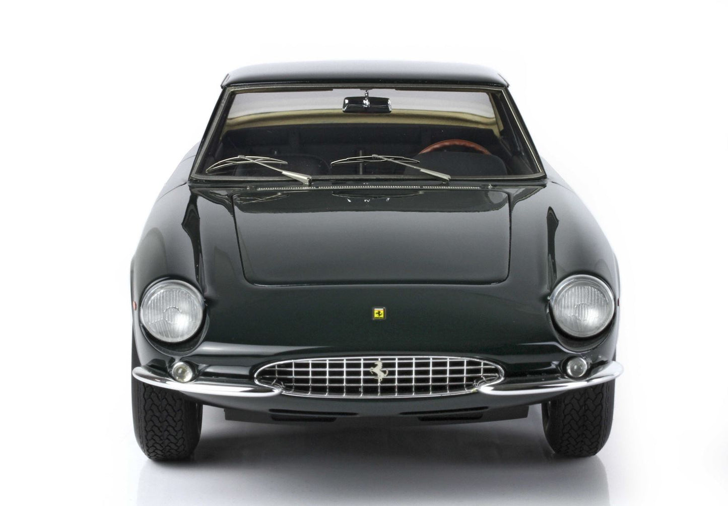 Classic dark green Ferrari GT car front view with chrome grille, available on Vroomi platform
