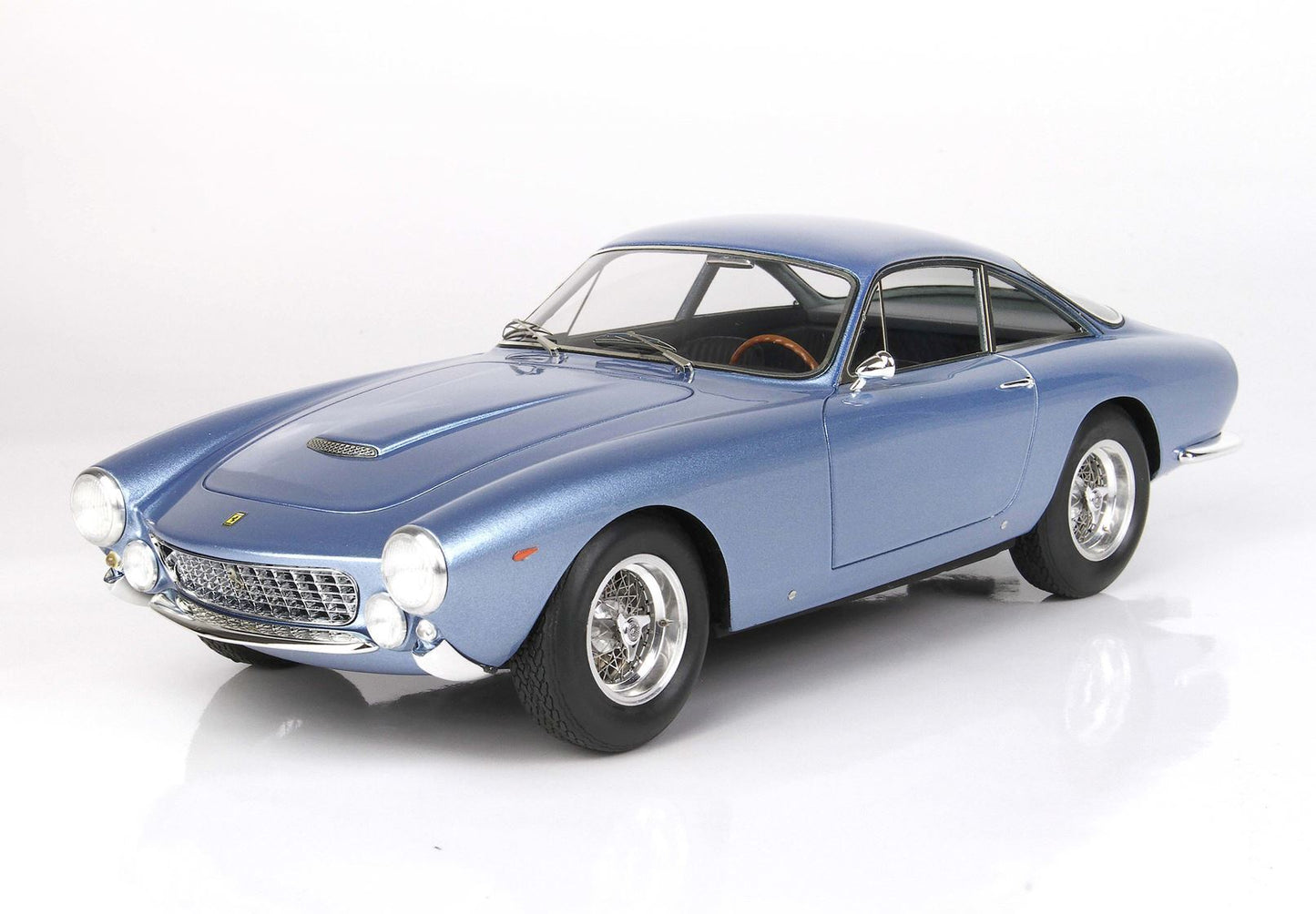 Blue classic sports car with chrome wire wheels and wooden steering wheel available on Vroomi