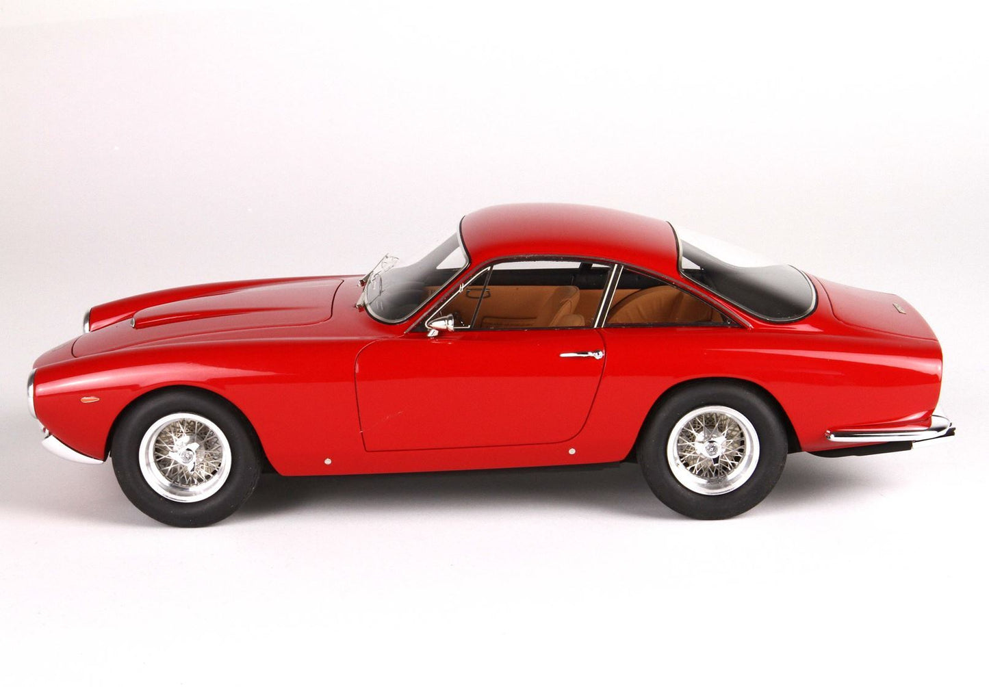 Classic red vintage sports car with wire wheels and tan interior, now available on Vroomi platform