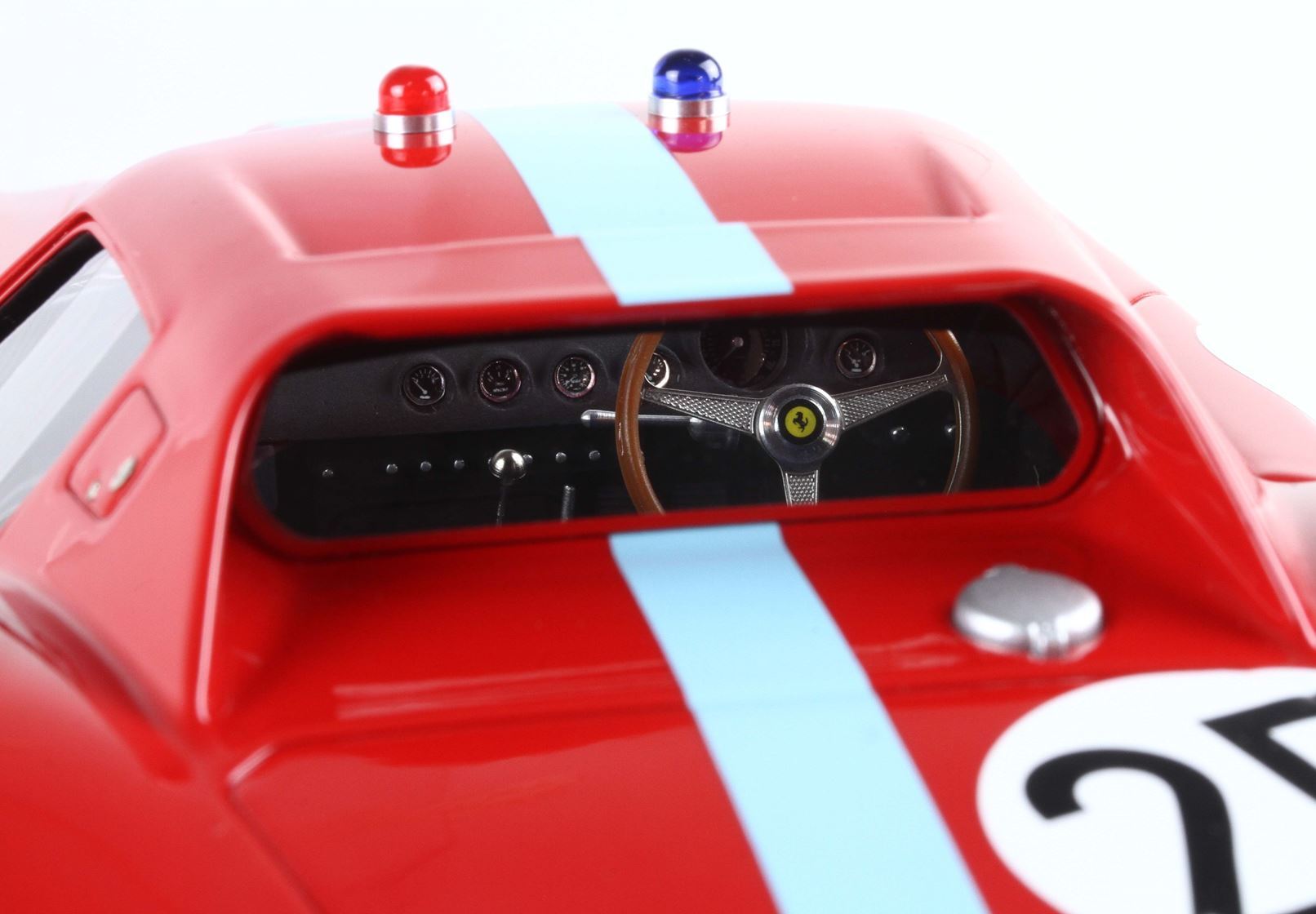 Red classic Ferrari race car model with light blue stripe and vintage dashboard, available via Vroomi