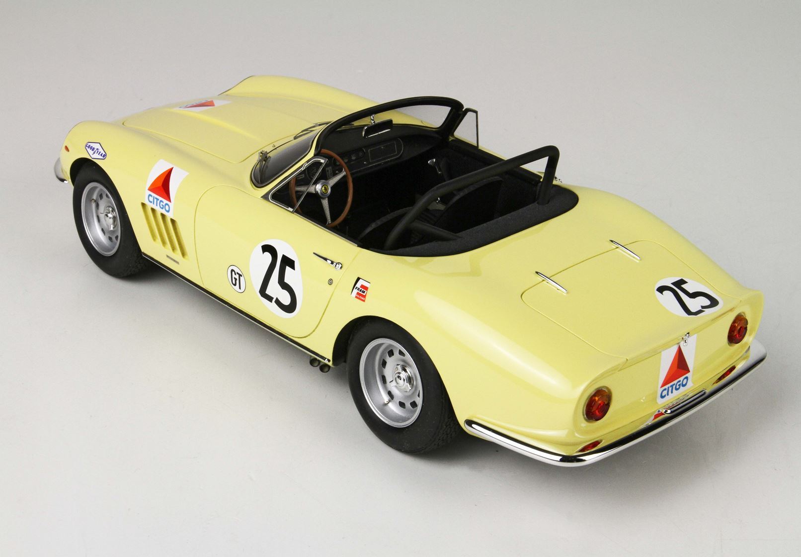 Yellow vintage Ferrari race car model with number 25, GT badge, sponsor decals, open cockpit, available on Vroomi