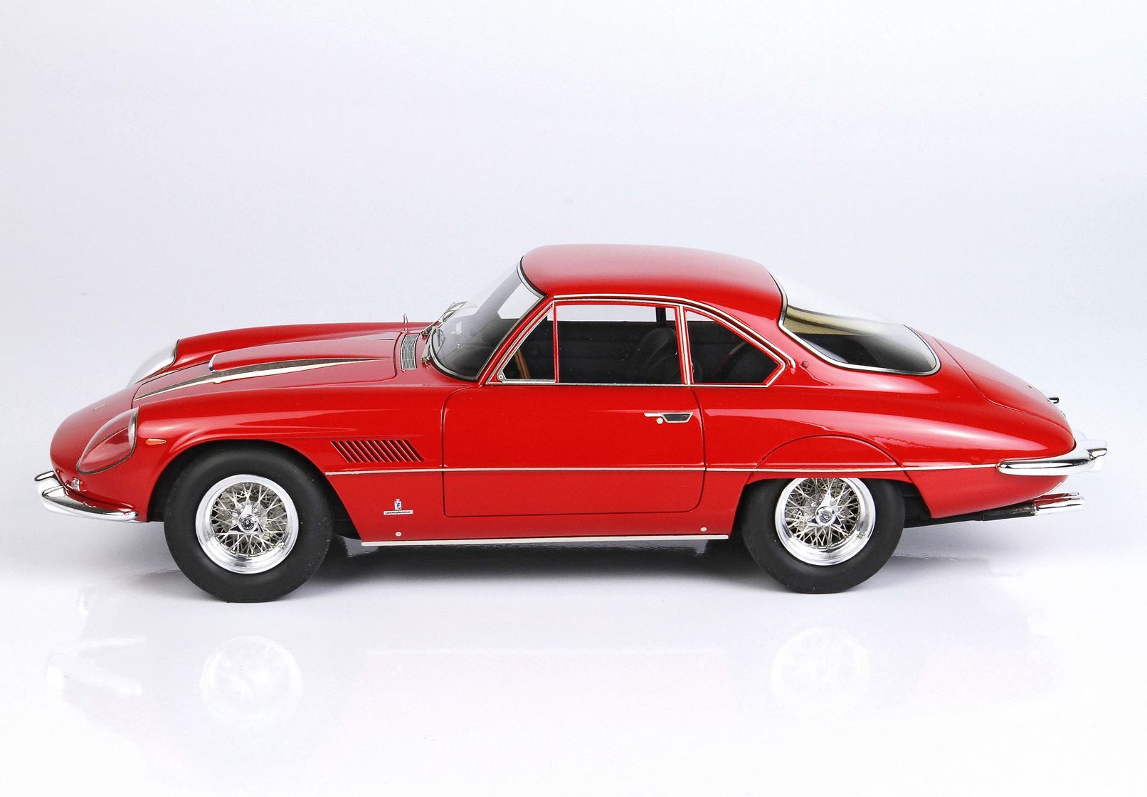 Classic red vintage sports car with wire-spoke wheels, sleek design available on Vroomi