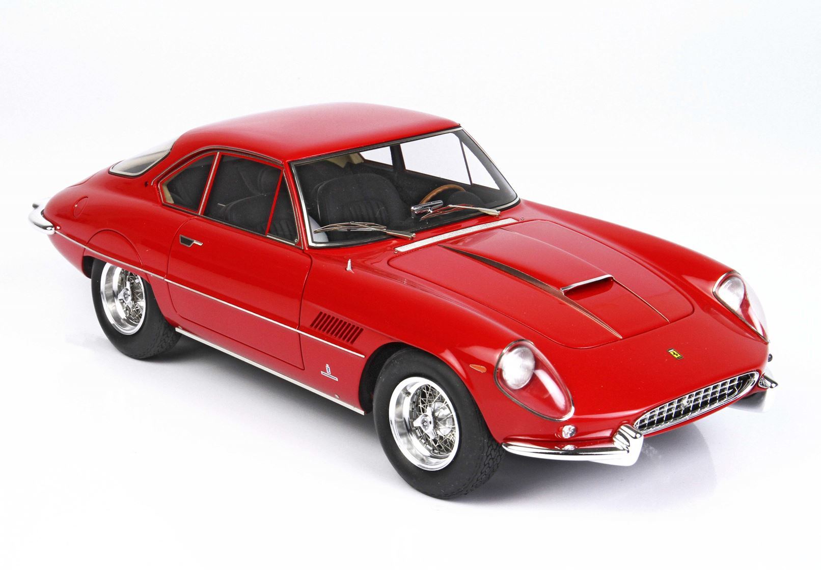 Red classic Ferrari model car with chrome wheels on white background, available on Vroomi
