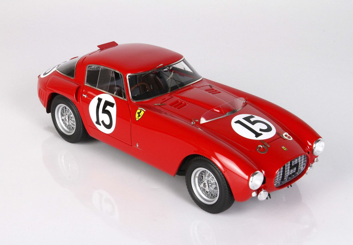 Red vintage Ferrari race car with number 15 decals, wire wheels, and available on Vroomi platform