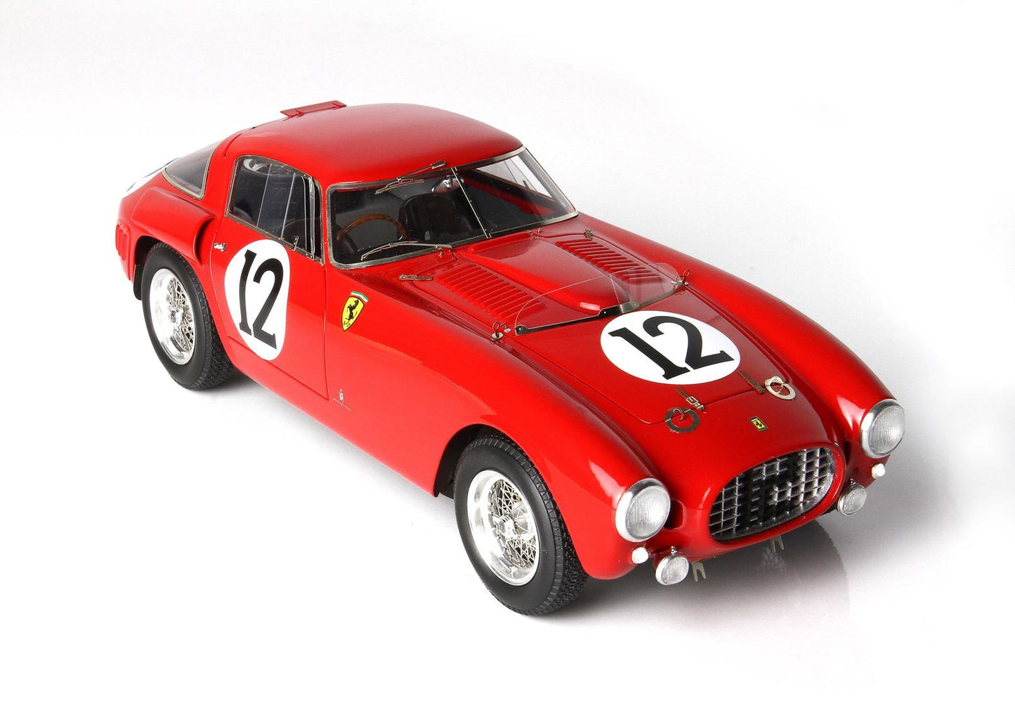 Red vintage Ferrari race car with number 12 on hood and side, classic wire wheels, offered on Vroomi