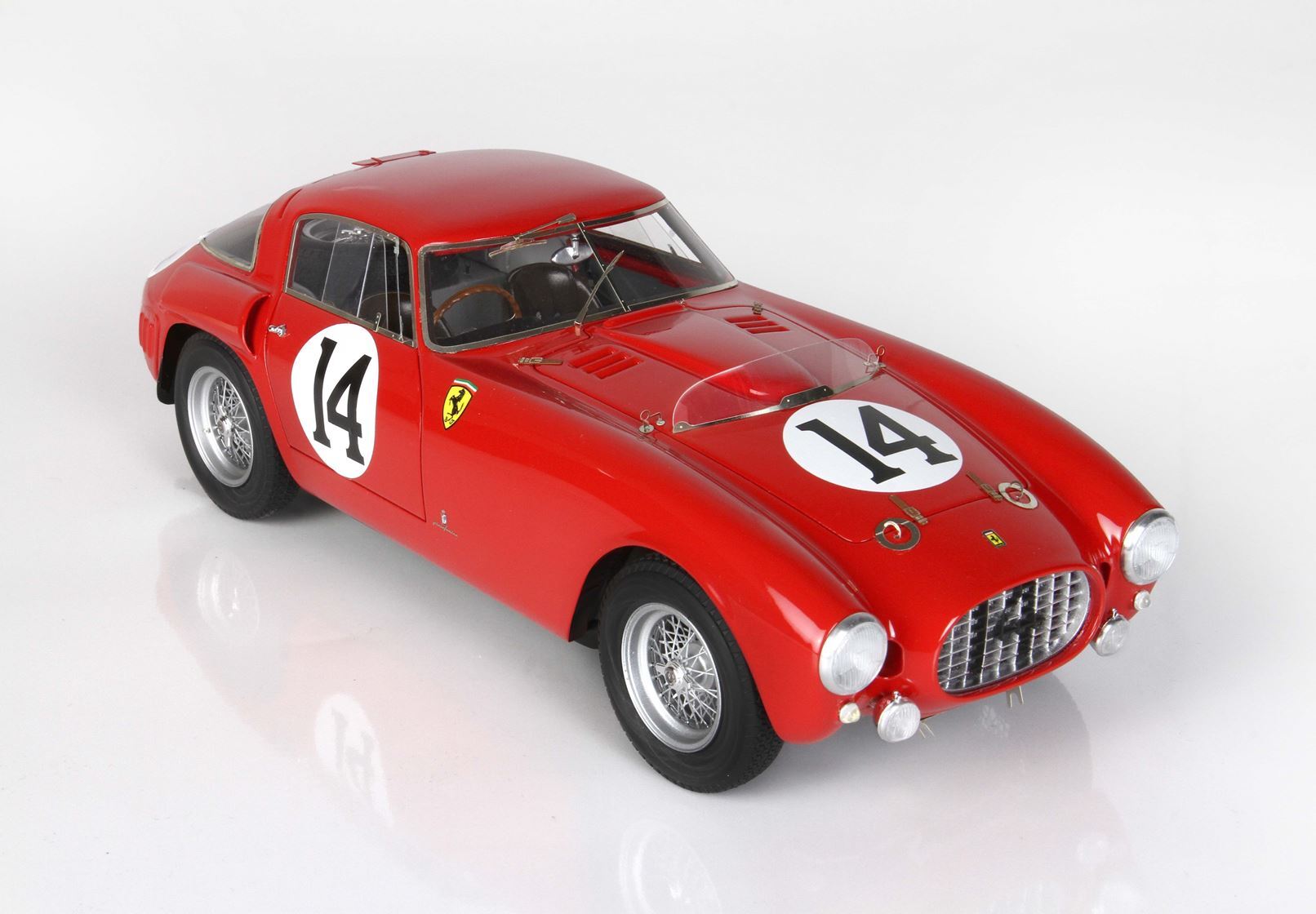 Red vintage Ferrari race car with number 14 decals, classic wire wheels, detailed interior, offered via Vroomi