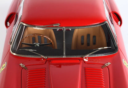 Close-up of red vintage model car with brown seats, steering wheel, and Ferrari badge, available via Vroomi