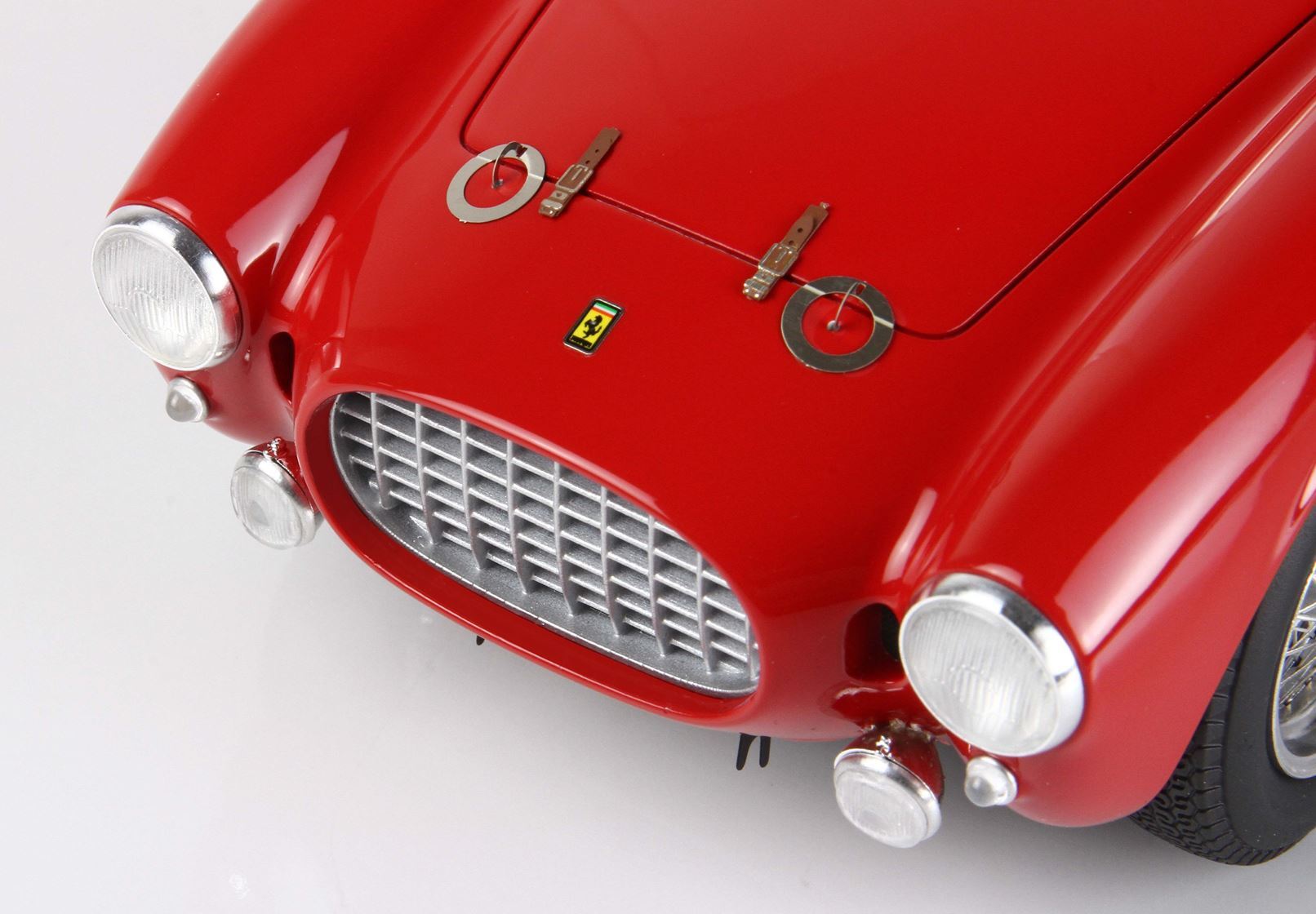 Close-up of red vintage Ferrari front grille and headlights, available through Vroomi platform