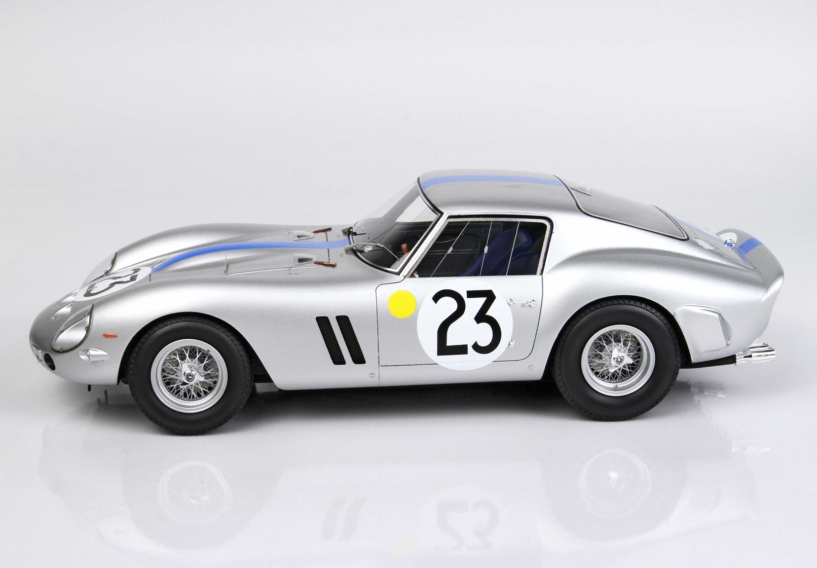 Silver classic race car number 23 with blue stripe and wire wheels, available on Vroomi