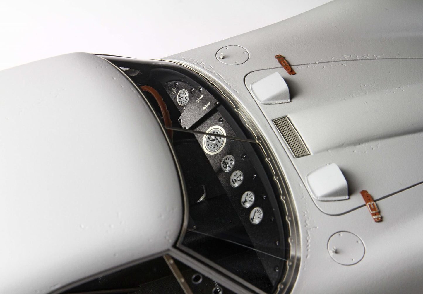 Close-up of vintage race car dashboard with detailed gauges and gray body, offered on Vroomi