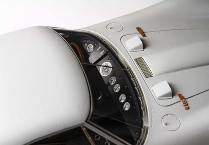 Close-up of vintage race car dashboard with detailed gauges and gray body, offered on Vroomi