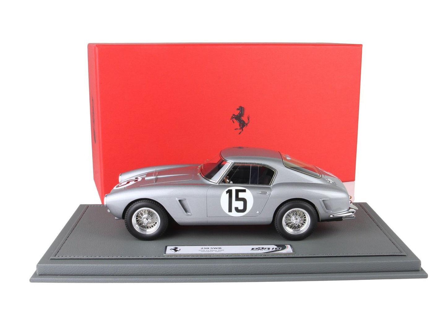 Silver Ferrari 250 SWB model car with number 15 on door, displayed on gray base with red Ferrari box, sold on Vroomi