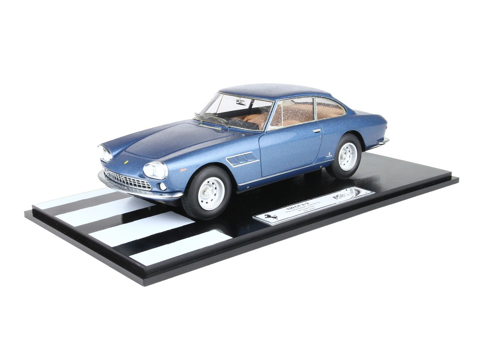 Blue classic Ferrari 330 GTC 1:18 scale model on black striped display, available via Vroomi