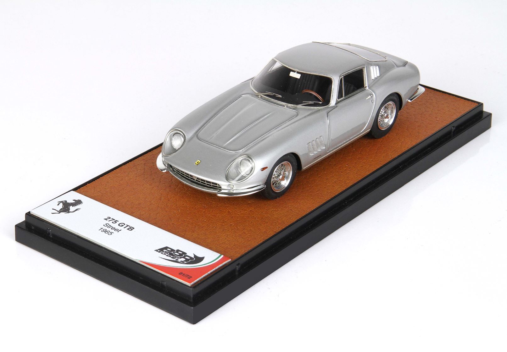 Silver 1965 Ferrari 275 GTB model on display stand with brown base, available on Vroomi