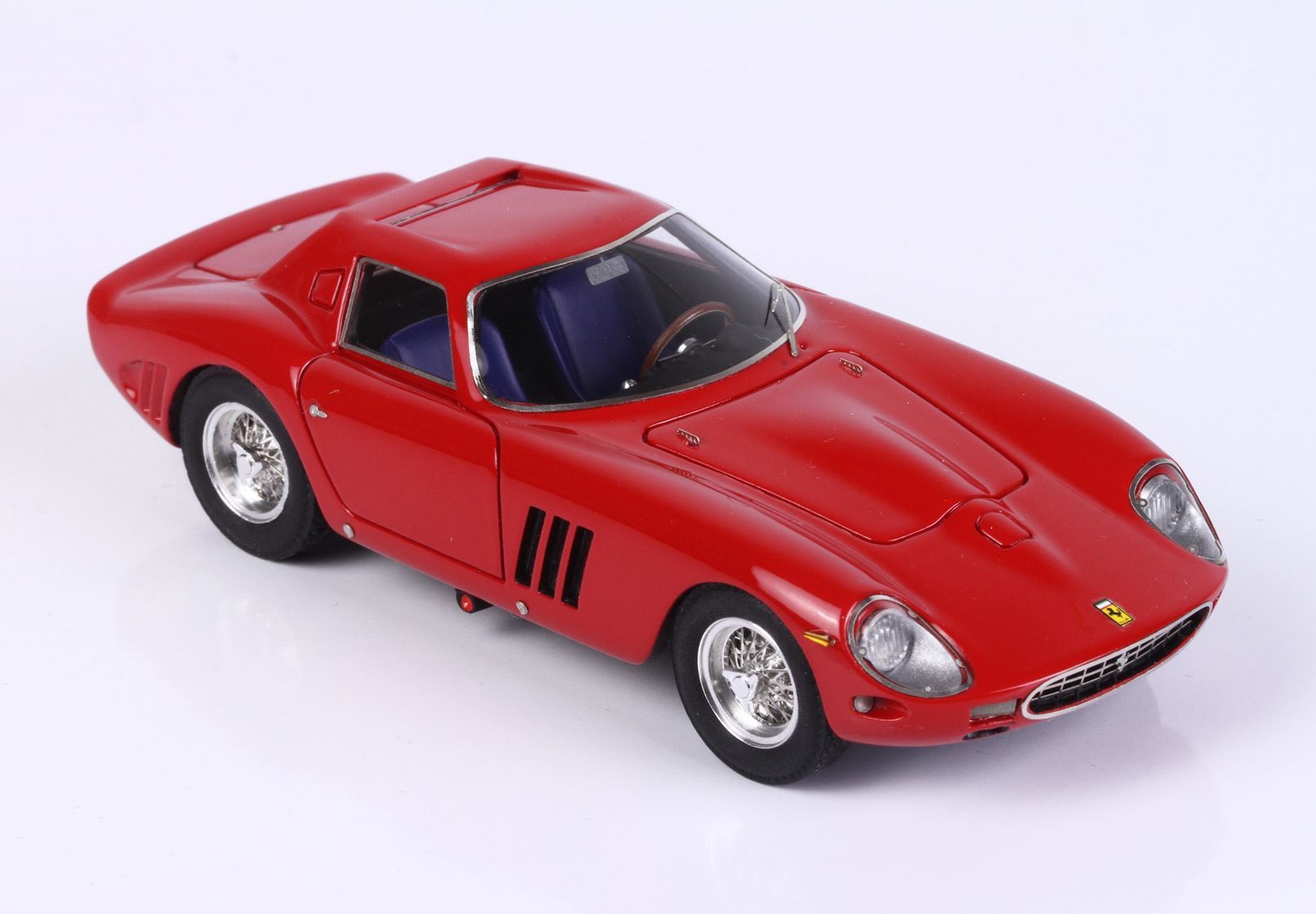 Red classic sports car model with chrome wheels and blue interior, available on Vroomi platform