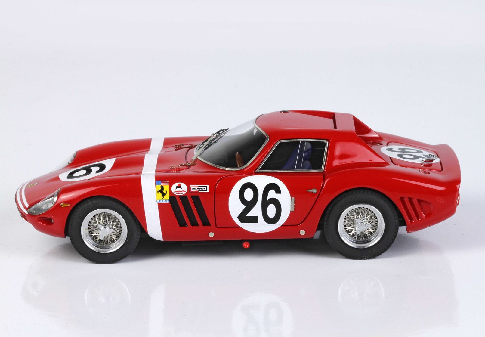 Red vintage race car model with number 26 and racing decals, available on Vroomi platform