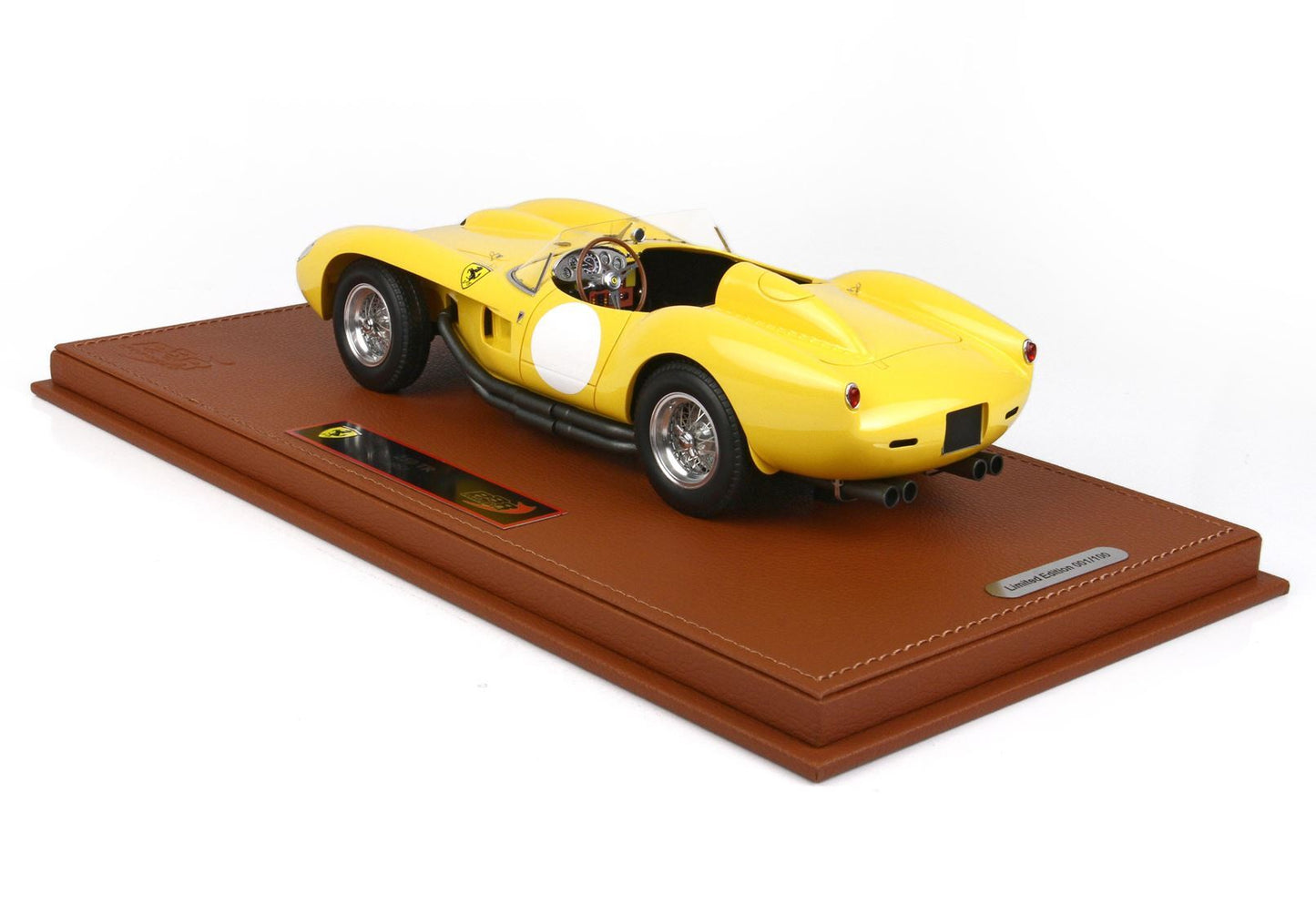 Yellow Ferrari race car model on brown leather base with limited edition plaque, now offered on Vroomi