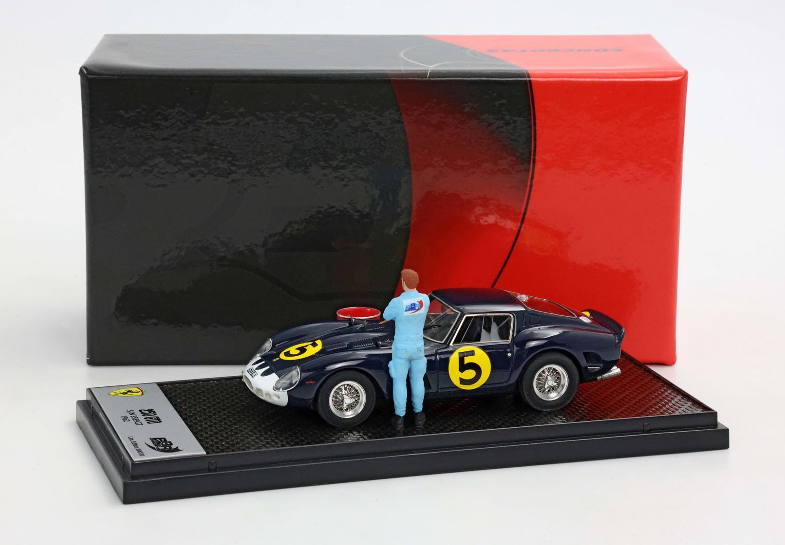 Scale model of black vintage race car with number 5 and mechanic figure, packaged for sale, also available on Vroomi