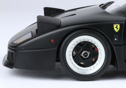 Close-up of black Ferrari race car front wheel and side with Ferrari emblem, offered on Vroomi