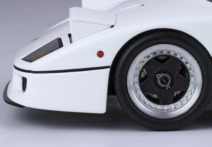 Close-up of white sports car front wheel and side, featuring black and silver rims, available on Vroomi