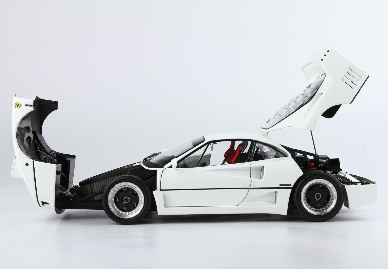 White Ferrari F40 sports car with front and rear hoods open, detailed engine and interior, offered on Vroomi