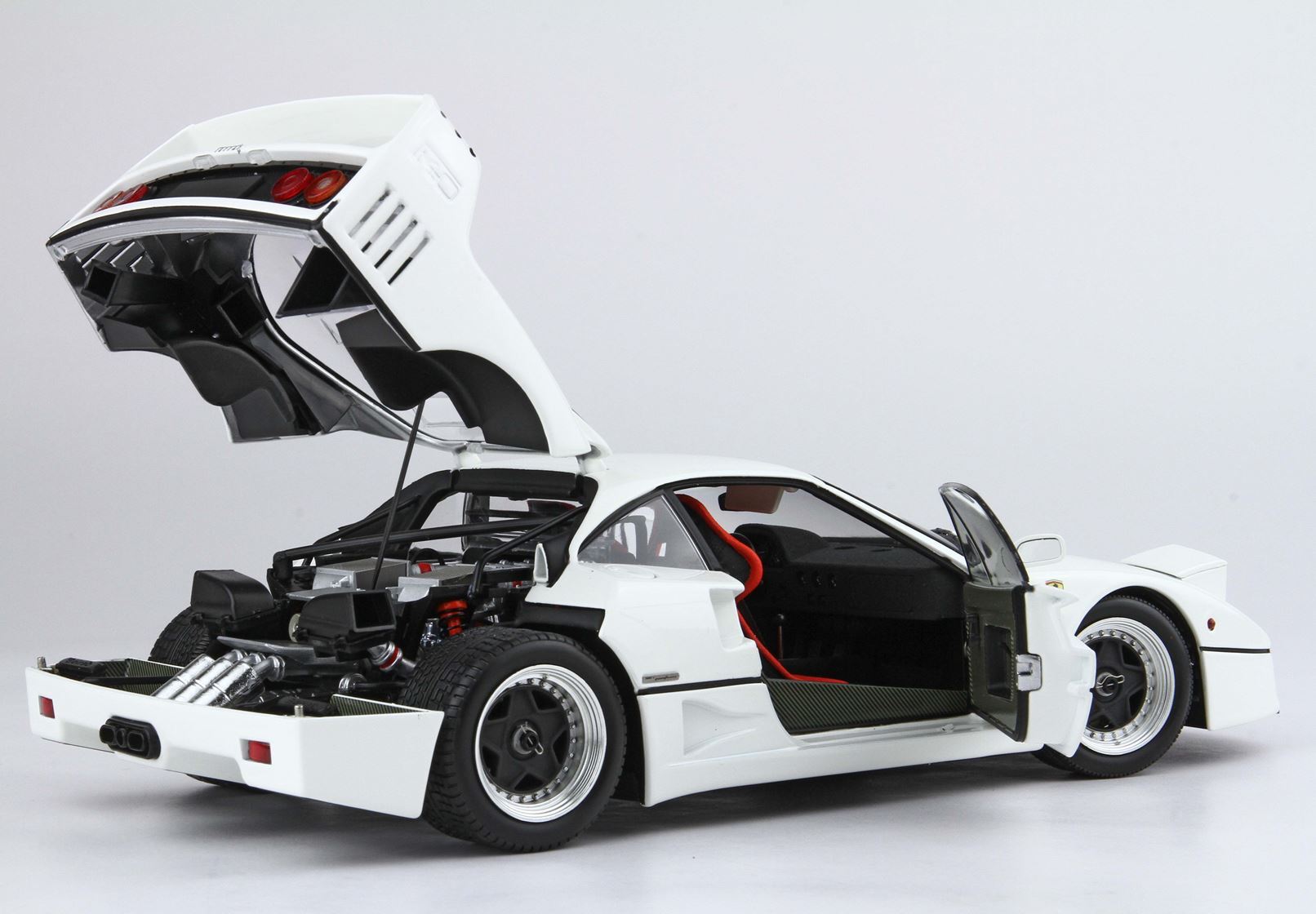 White sports car model with doors and rear hood open showing interior and engine, available on Vroomi