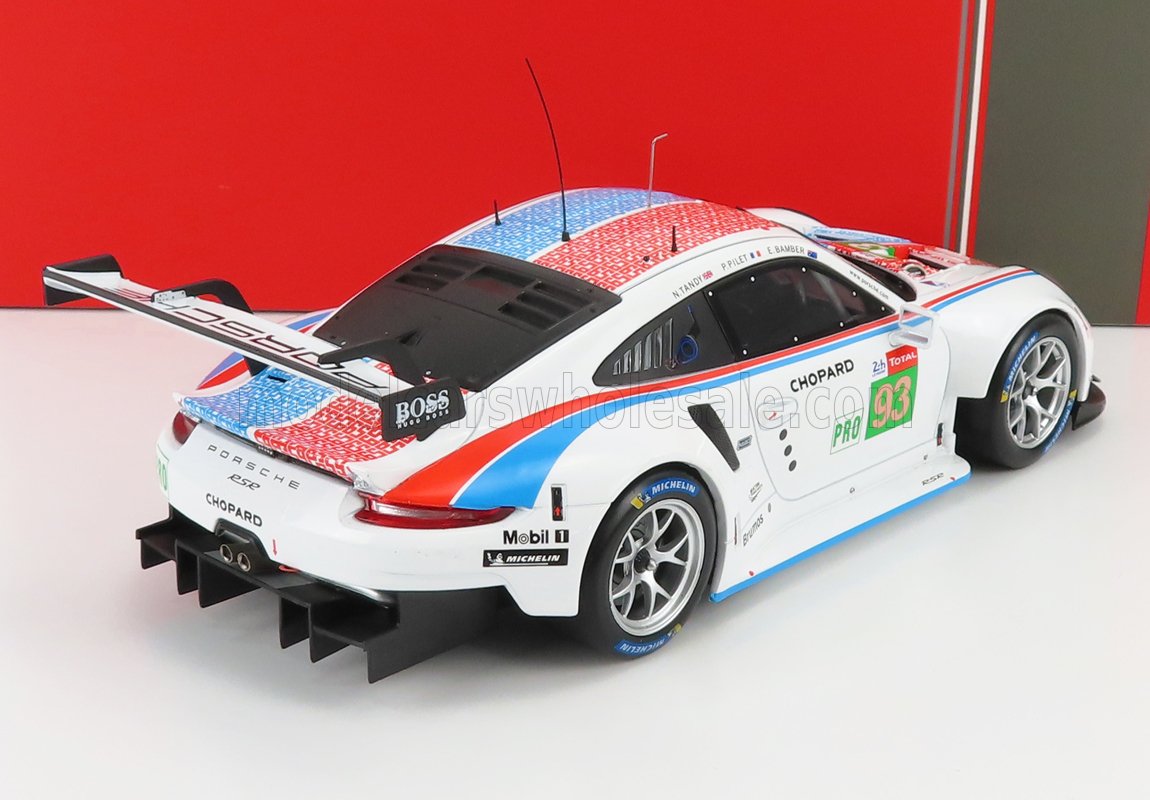 Modellino di auto da corsa Porsche 911 RSR bianca con strisce rosse e blu, pneumatici Michelin e adesivi degli sponsor, disponibile su Vroomi.