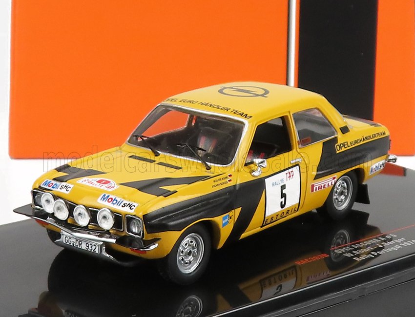 Modellino di auto da rally Opel gialla e nera con il numero 5 sulla portiera, su un supporto nero, disponibile su Vroomi.