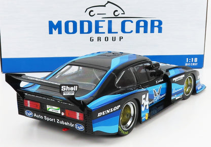 Modellino di auto da corsa Porsche in scala 1:18, nero e blu, con i loghi degli sponsor, disponibile su Vroomi.