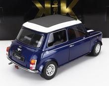 Modellino di auto Mini Cooper classica blu con tetto bianco, ruote dettagliate e dettagli cromati, disponibile tramite Vroomi.