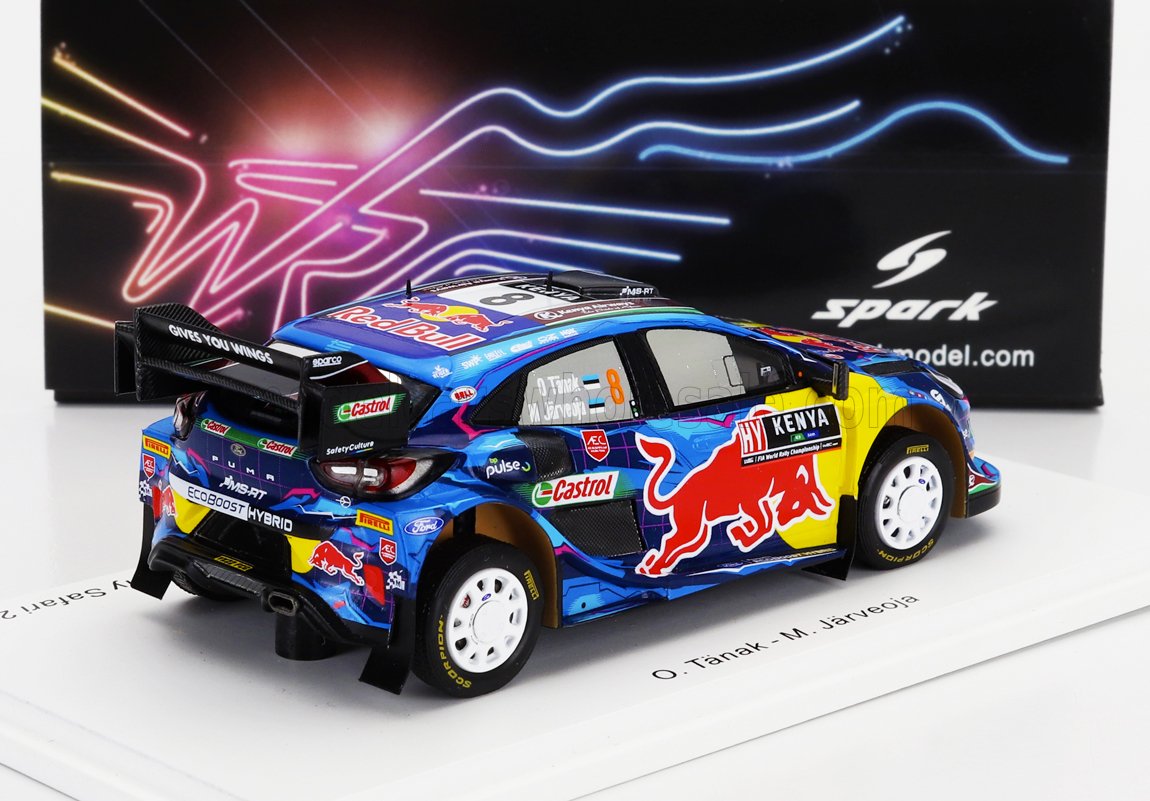 Modellino di auto da rally Red Bull blu con sponsorizzazione Kenya, esposto su una piattaforma bianca, disponibile su Vroomi.