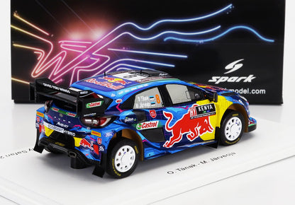 Modellino di auto da rally Red Bull blu con sponsorizzazione Kenya, esposto su una piattaforma bianca, disponibile su Vroomi.