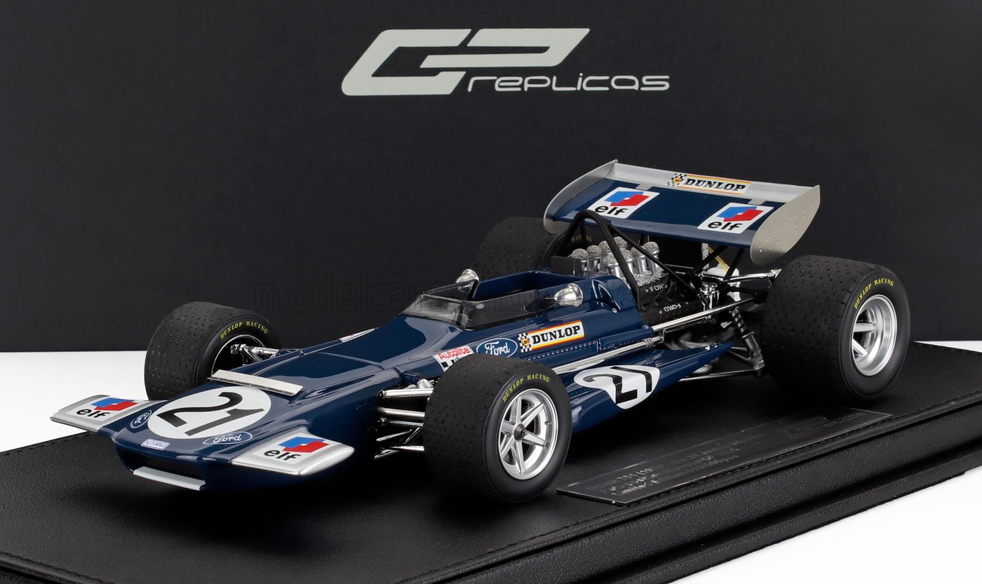 Modellino vintage blu di un'auto da corsa Ford Formula 1 con i loghi Dunlop ed Elf, esposto su una base nera, disponibile su Vroomi.