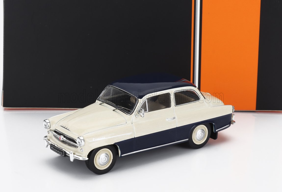 Modello classico di auto vintage bicolore beige e blu navy su sfondo bianco, disponibile su Vroomi.
