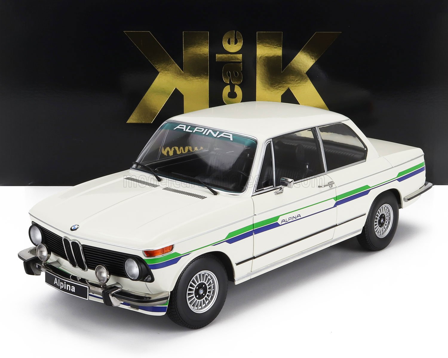 Modellino di auto classica BMW Alpina bianca con strisce blu e verdi, disponibile su Vroomi.