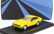 Yellow Anadol STC-16 model car 1973 on display stand with geometric blue black backdrop, available on Vroomi
