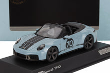 Blue Porsche 911 Spirit 70 convertible model car with black racing stripes, displayed on black stand, offered on Vroomi