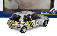 Modellino di auto da rally Renault 5 GT Turbo color argento con strisce gialle, adesivi da corsa e confezione Solido, disponibile su Vroomi.